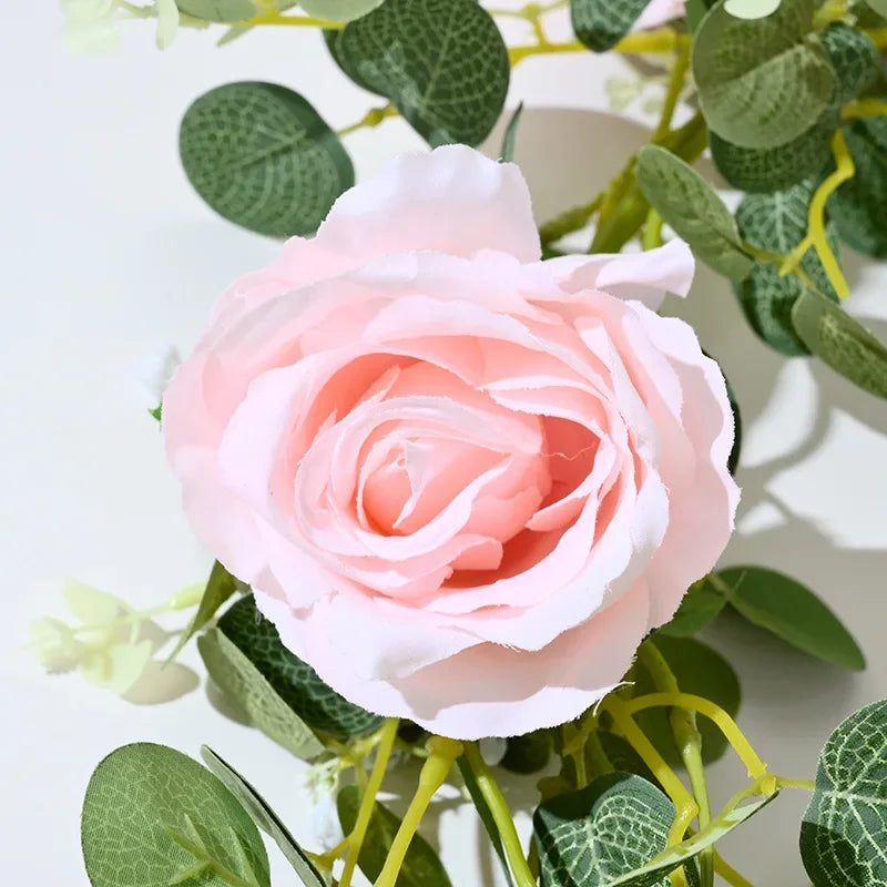 Artificial pink flowers and green plants for interior decoration