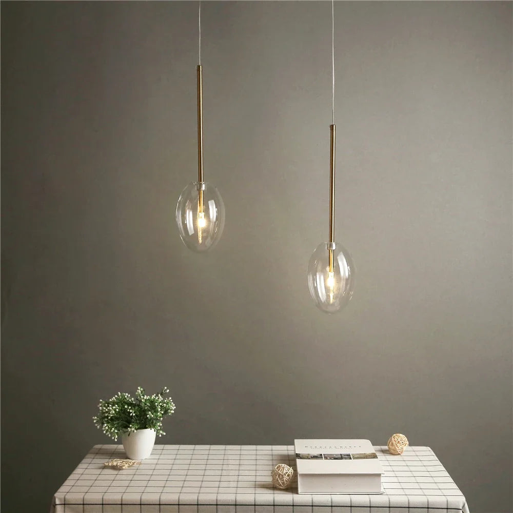 Transparent glass pendant light in the shape of decorative water drop