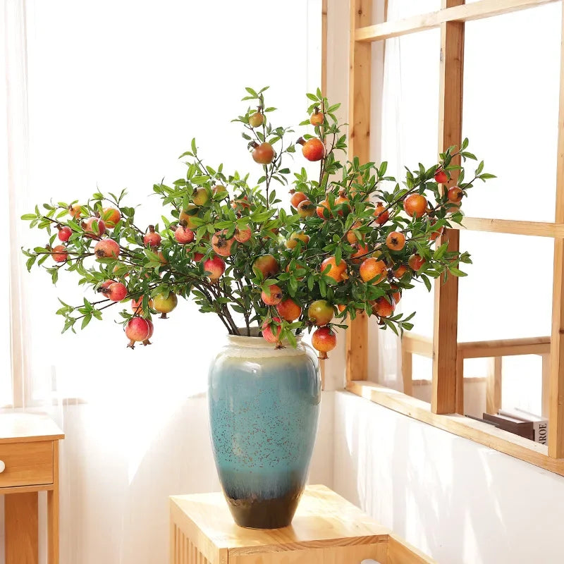 Garden decoration with artificial grenades and green plants