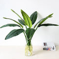 Tropical floral arrangement with birds and decorative bananas wedding