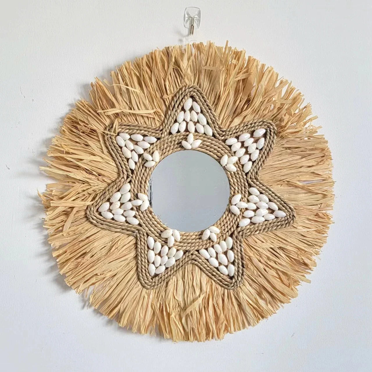 Decorative mirror in raffia and shells for wall decoration
